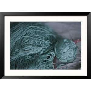  A Ball of Green Silk Yarn Lies Near a Pile of Unwound Yarn 