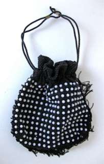 black beading on black fabric; black fringe around three sides; black 