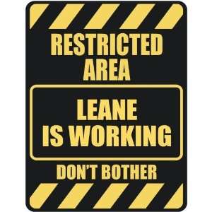   RESTRICTED AREA LEANE IS WORKING  PARKING SIGN