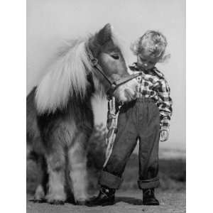 Child Standing Beside a Miniature Horse, Showing Size 